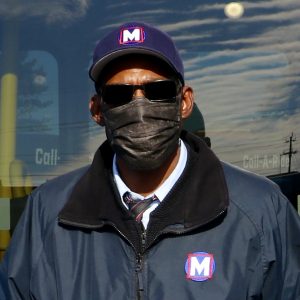 Metro Call‑A‑Ride 2020 Operator of the Year Jerome, smiling at the camera and holding his certificate of achievement
